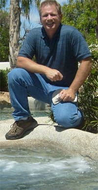 Kyle Elliott, owner of Pool Service Mesa AZ, servicing a backyard pool